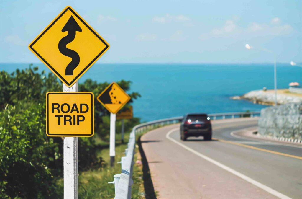 road trip word and curvy road sign