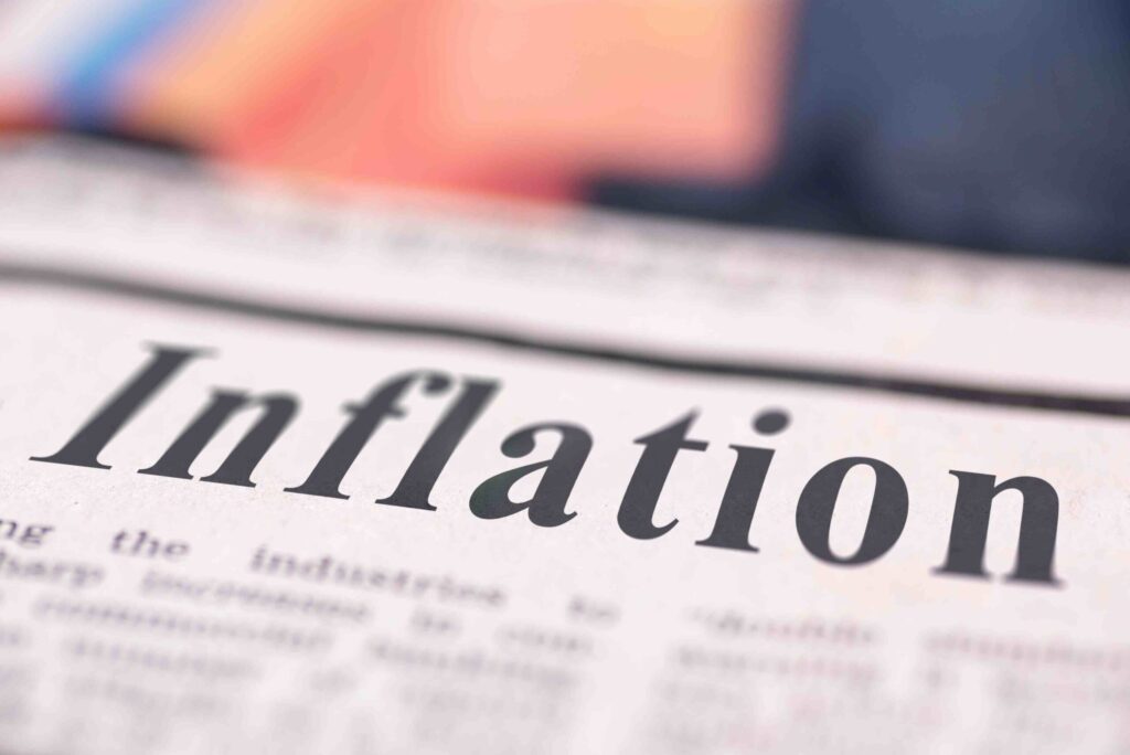 Inflation written newspaper close up shot to the text.