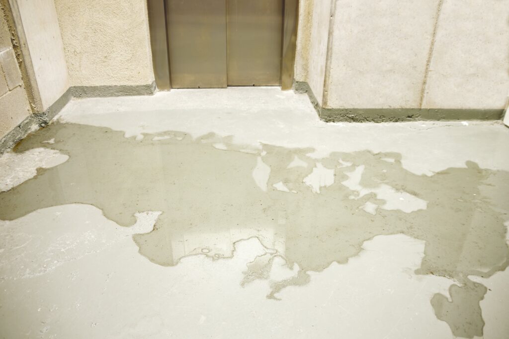 a dirty floor with a door and a window