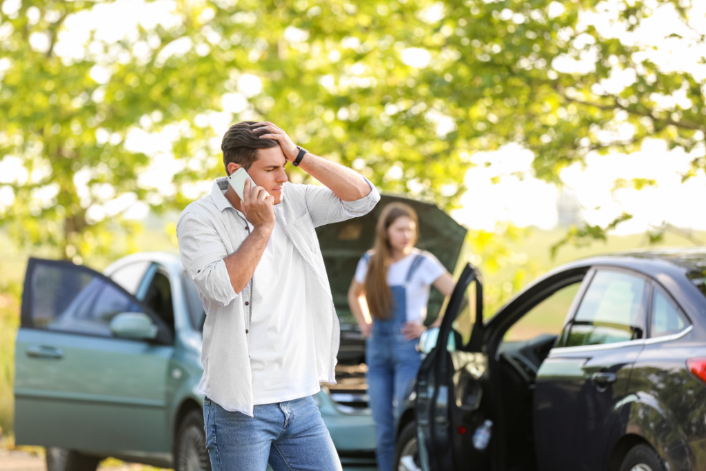 Man calling insurance after a car accident
