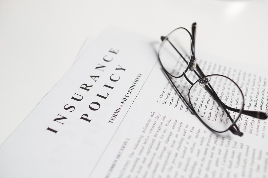 a pair of glasses sitting on top of an open book