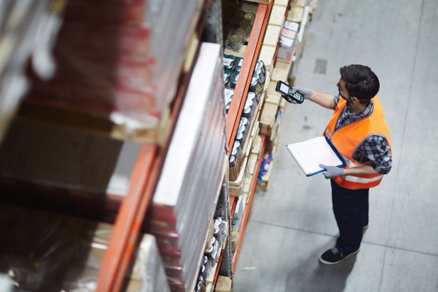 a man in an orange vest is holding a clipboard