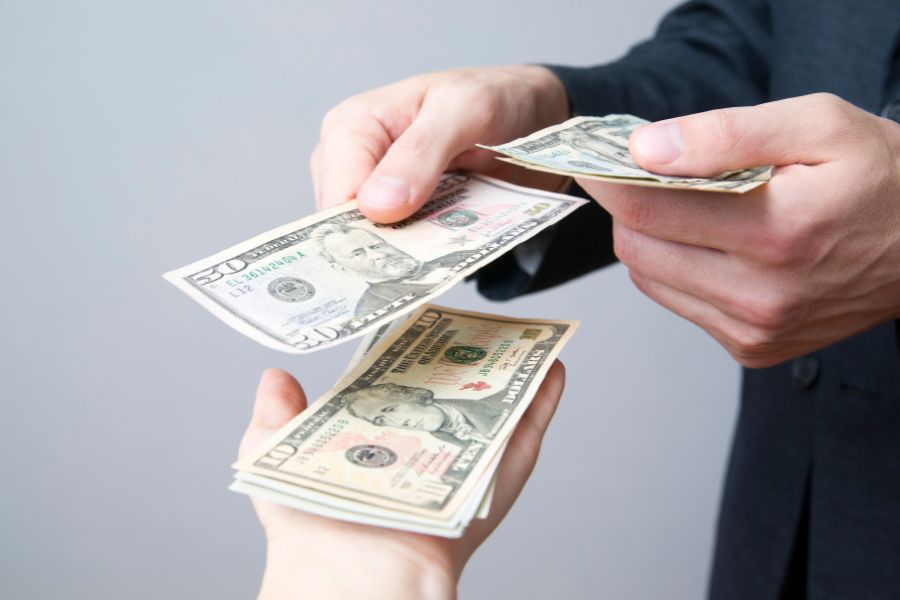 a person handing money to another person