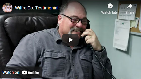 a man sitting in a chair talking on a phone