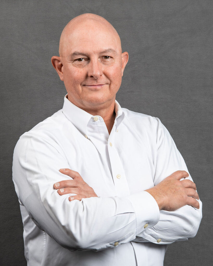 a man with his arms crossed posing for a photo