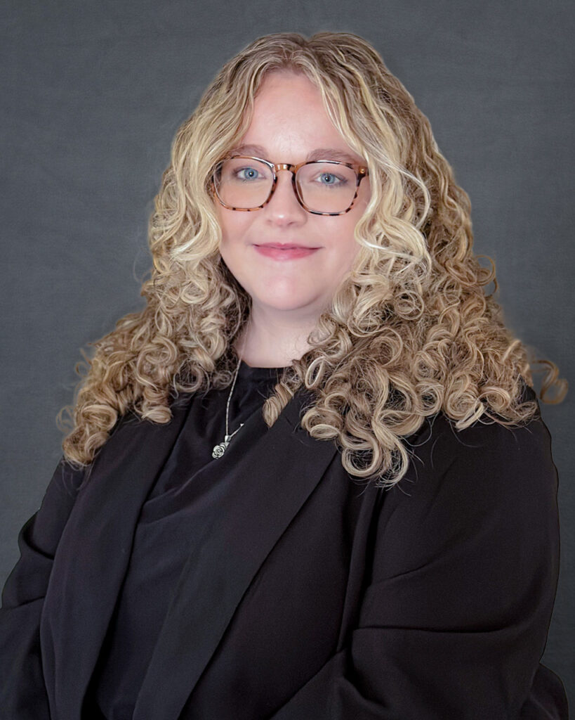 a woman wearing glasses and a black shirt