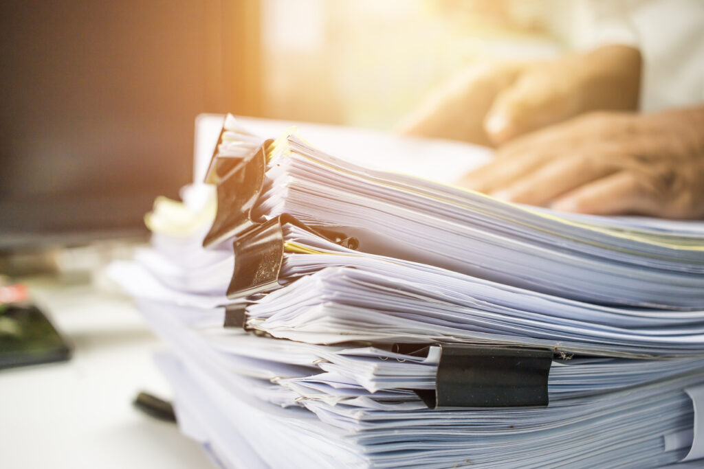 a stack of papers sitting on top of a desk