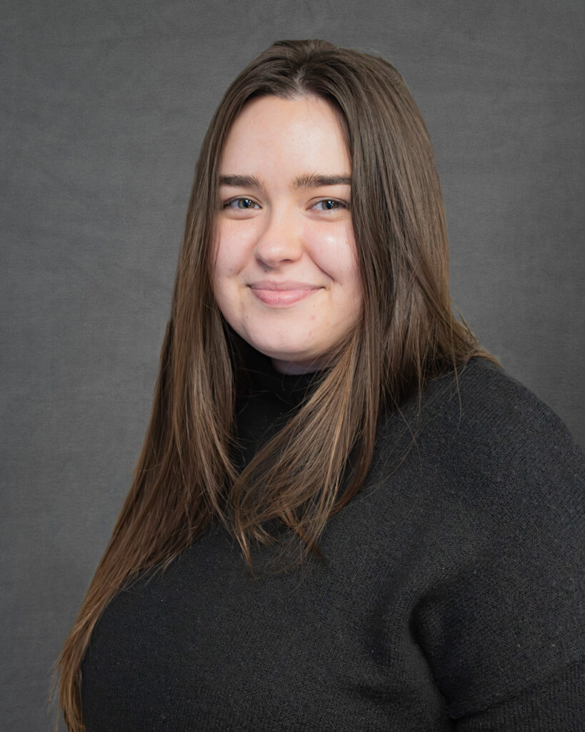 a woman in a black sweater posing for a picture