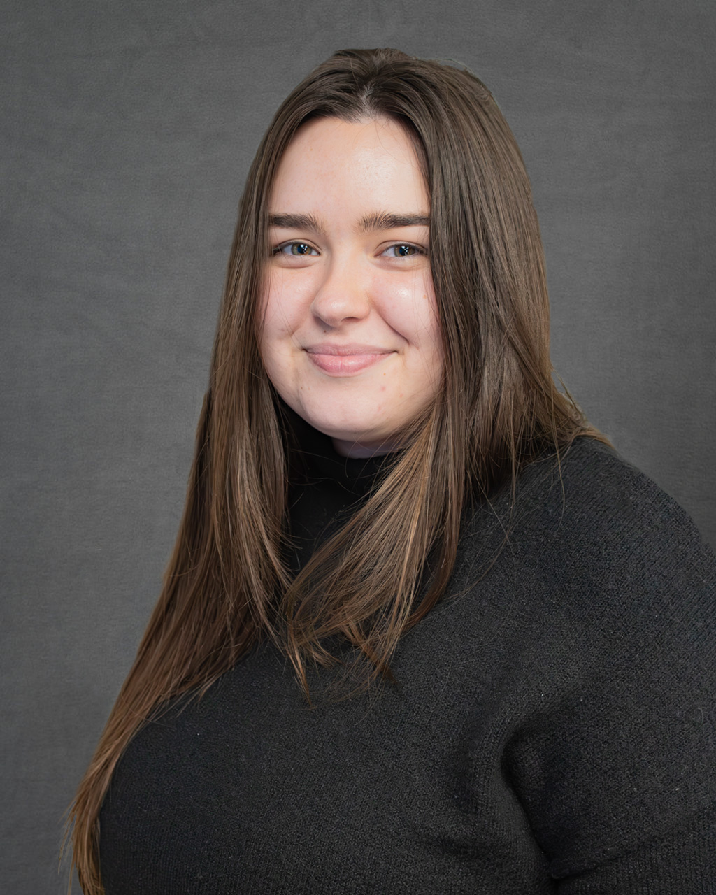 a woman in a black sweater posing for a picture