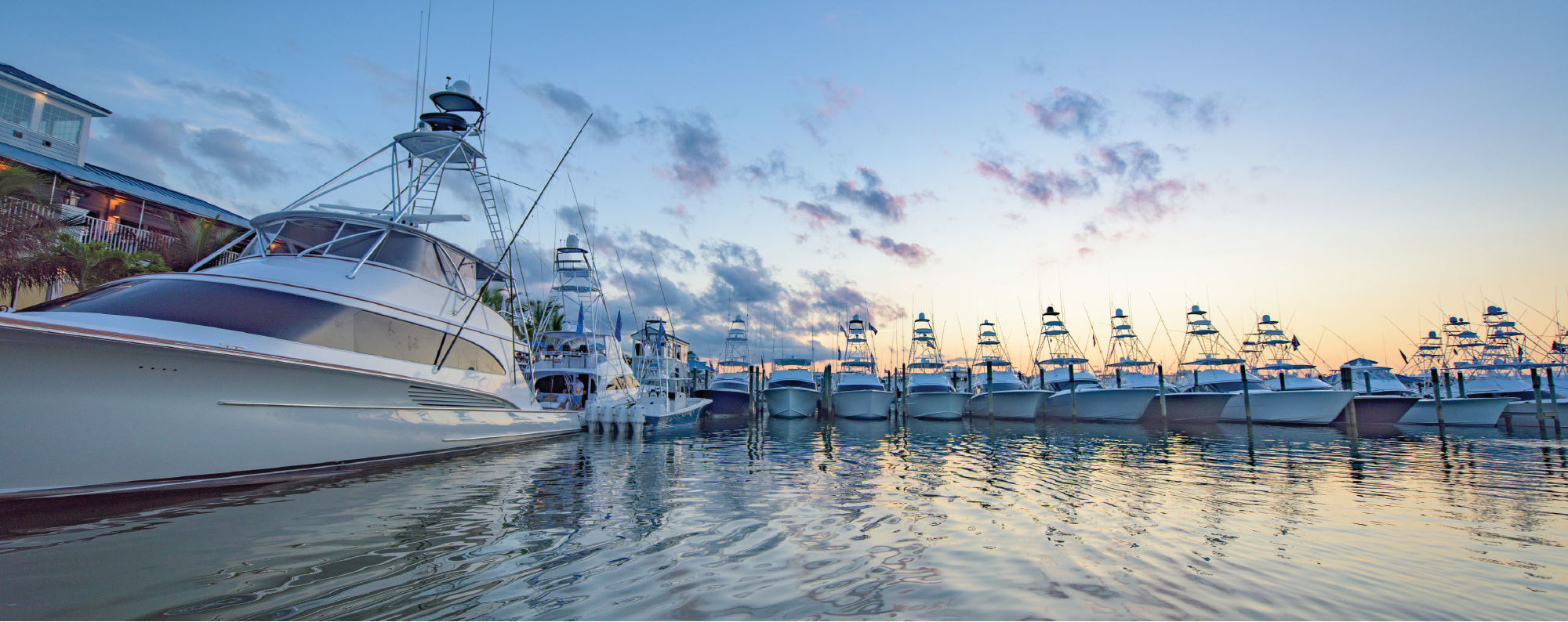 Boats in marina at sunset