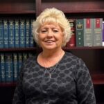 Rhonda Head Shot in front of Bookcase
