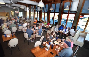people at tables and booths eating meals at airport