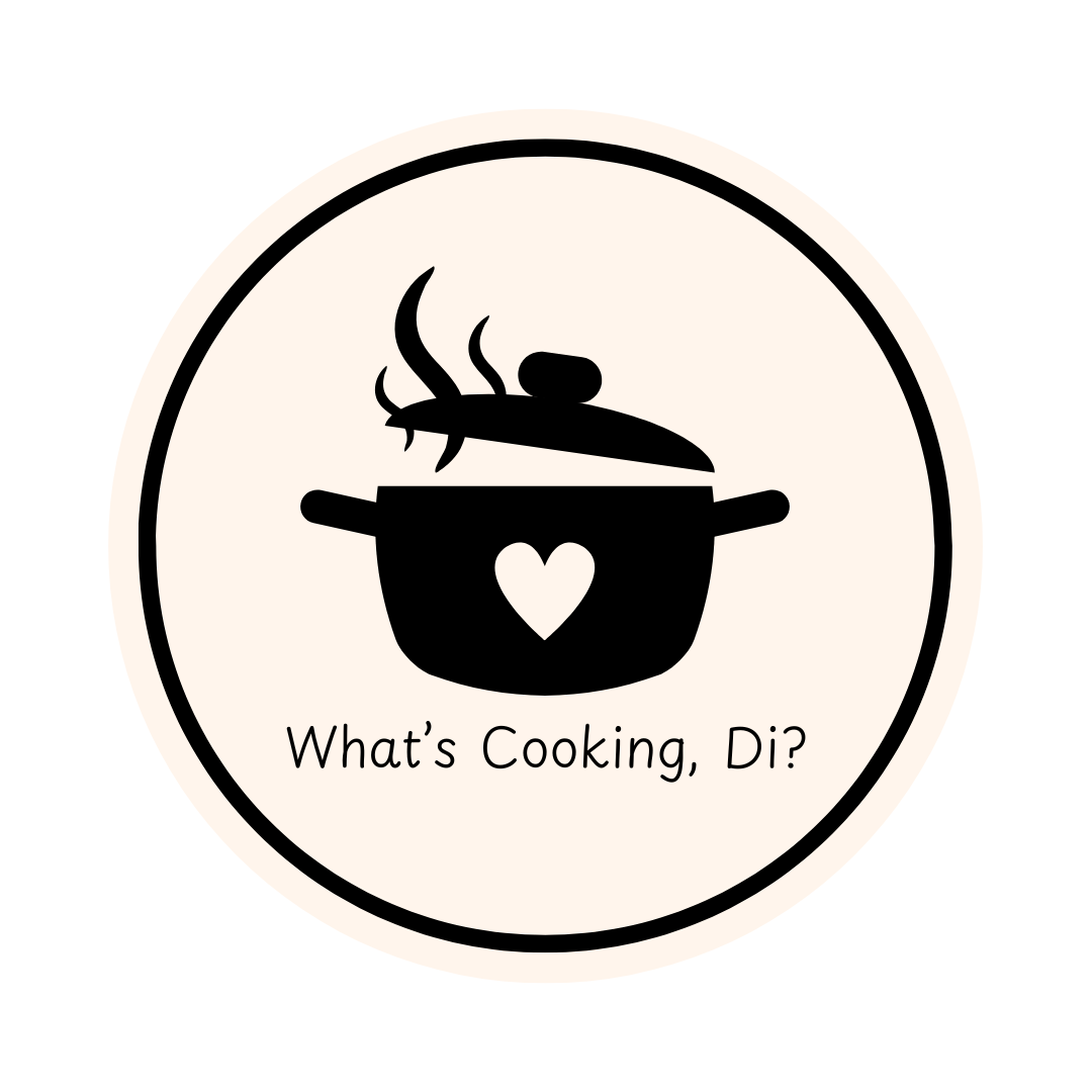 black colored cooking pot with a tan heart in the center. Below the pot is "What's Cooking Di?"