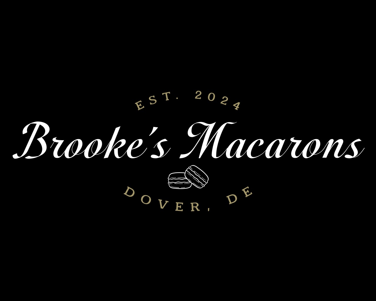 Black background logo for “Brooke’s Macarons.” The text reads “Brooke’s Macarons” in elegant white script, with “EST. 2024” above and “Dover, DE” below in gold uppercase letters forming a circular shape. At the center bottom is a simple line drawing of two stacked macarons.