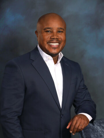 a man in a suit posing for a picture