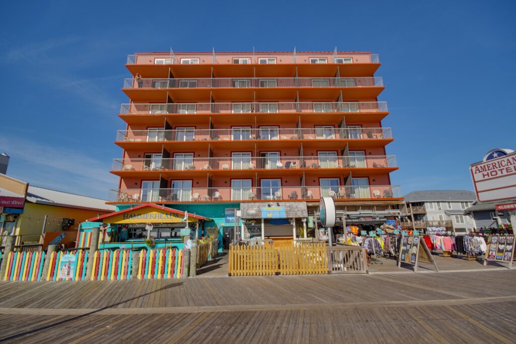 a large orange building sitting on the side of a beach