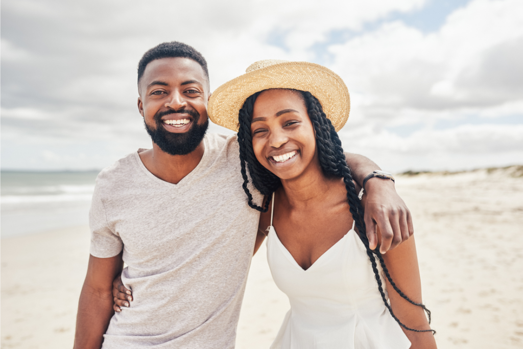 a man and a woman standing on a beach