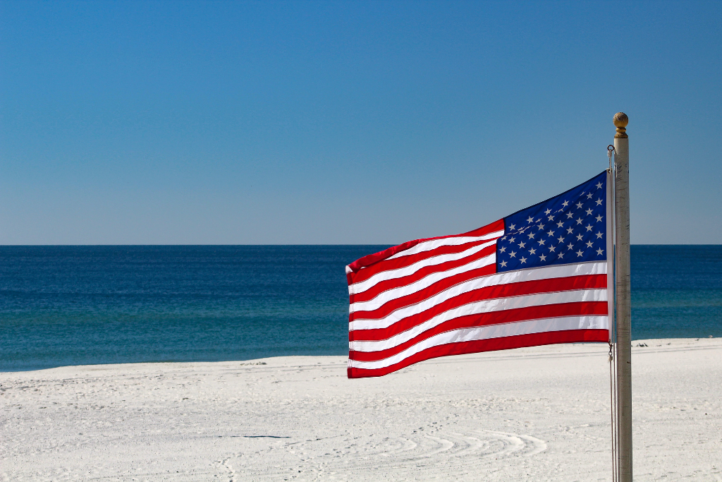 American flag with ocean in background
