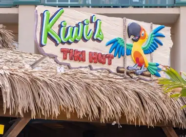 a tiki's tiki hut with a parrot painted on it