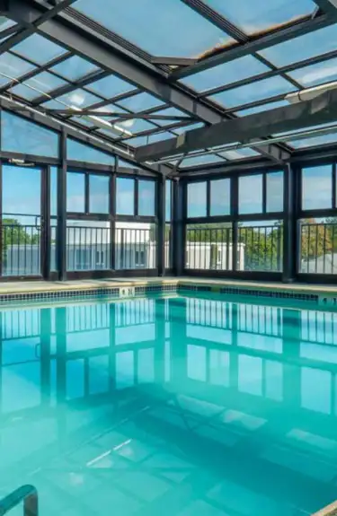 a large indoor swimming pool with glass walls