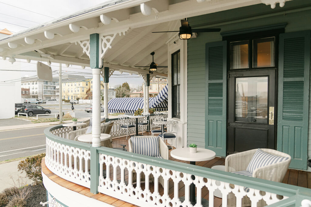 a porch with chairs and a table on it