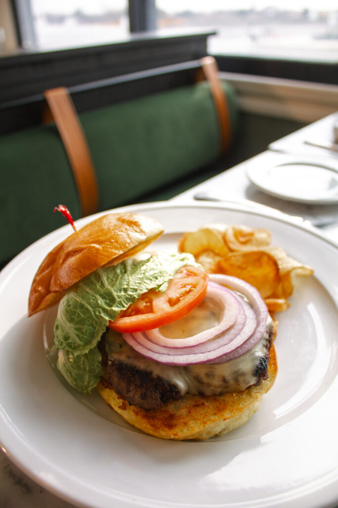 a burger with lettuce, tomato, onion and tomato slices