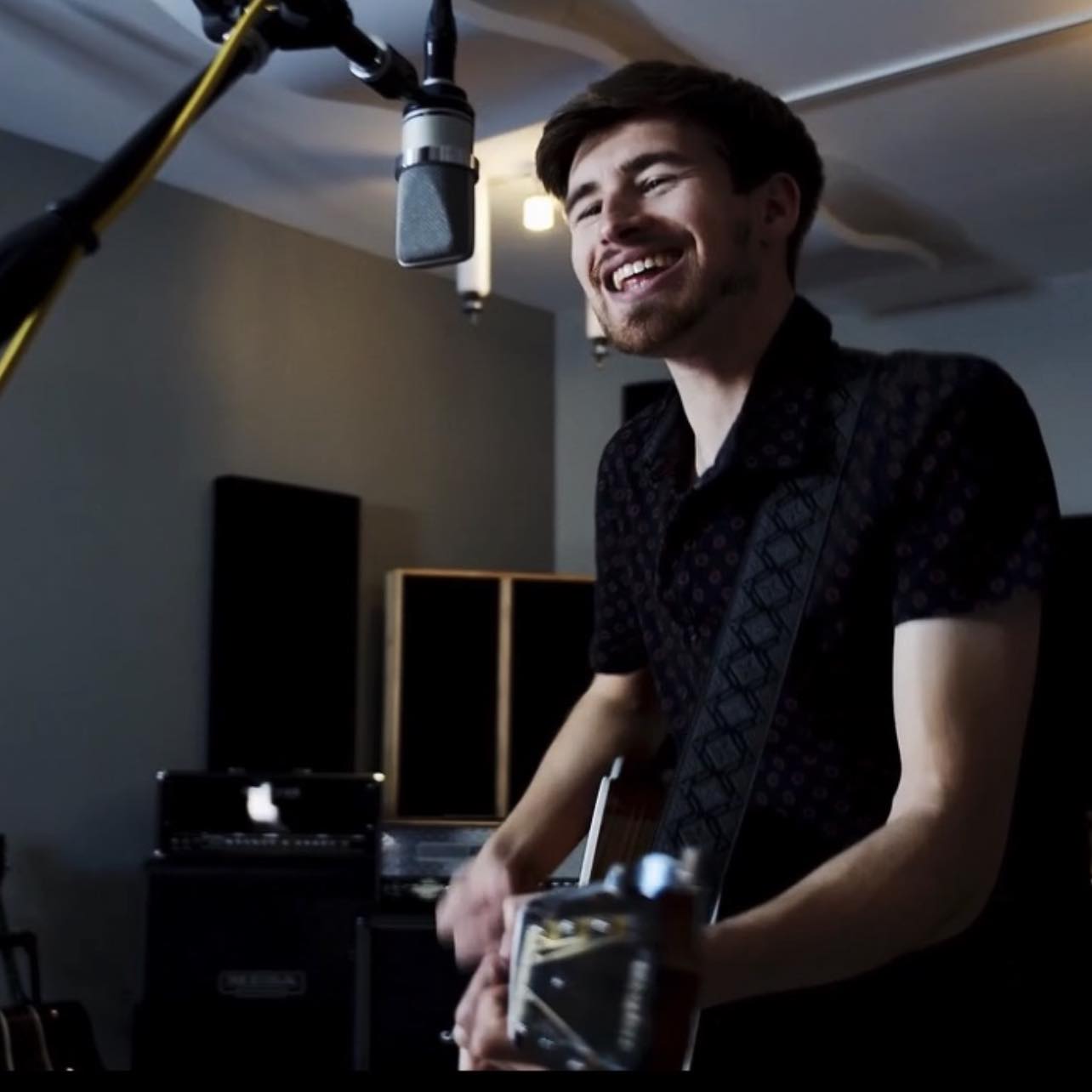 Andrew Moorer a man playing a guitar in a recording studio