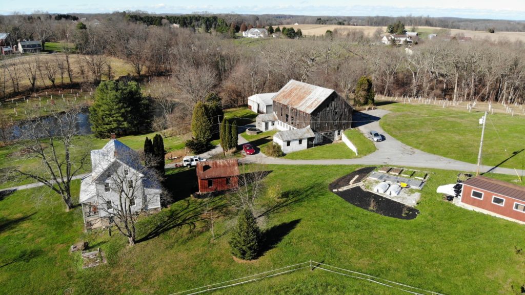 an aerial view of a farm with two barns