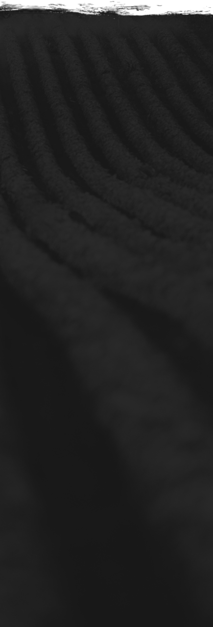 a black and white photo of a snowboarder going down a hill