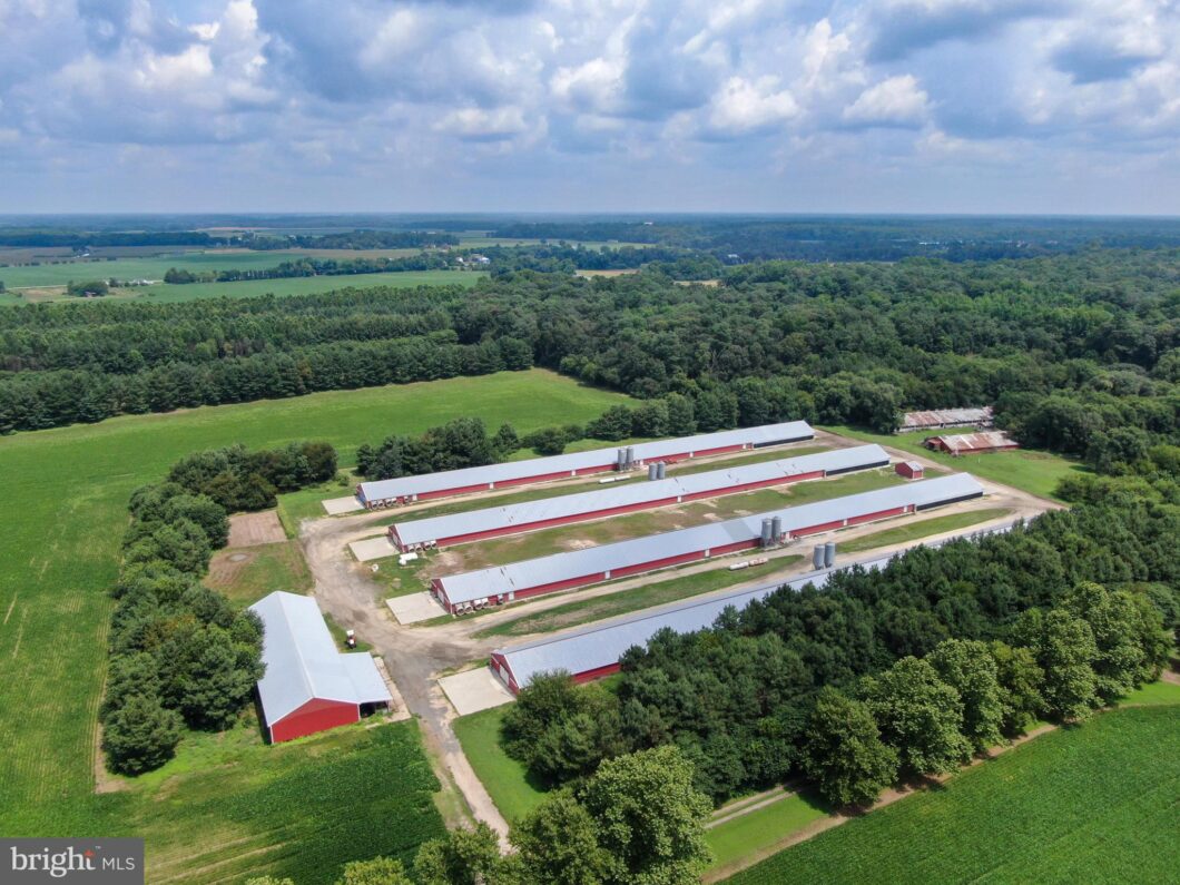 an aerial view of a farm with a barn and a lot of trees