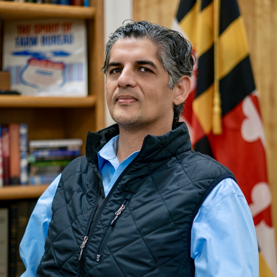 a man standing in front of a bookshelf