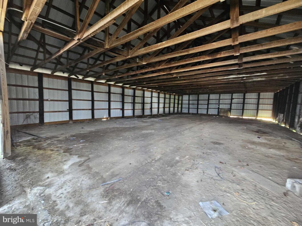 an empty warehouse with a lot of wood beams