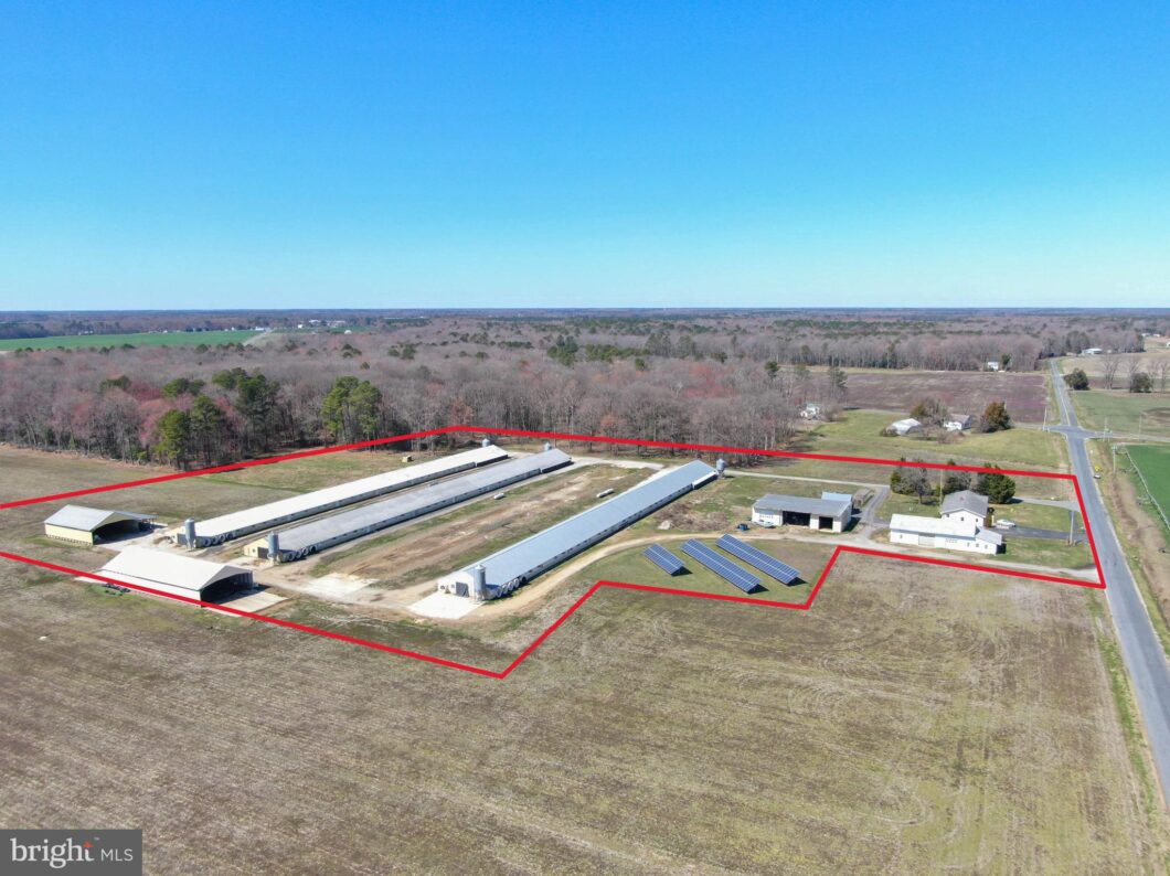 an aerial view of a farm in the middle of a field