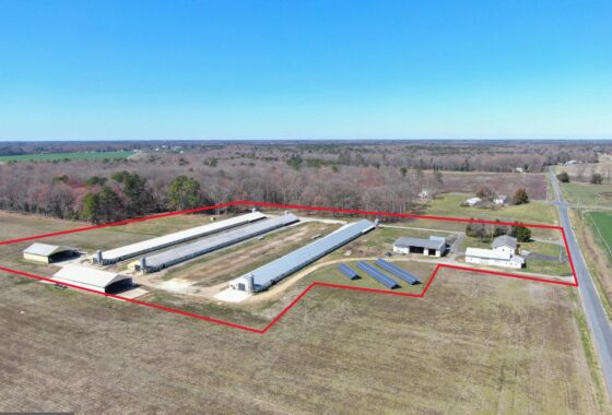 an aerial view of a farm in the middle of a field