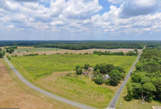 an aerial view of a large field and road