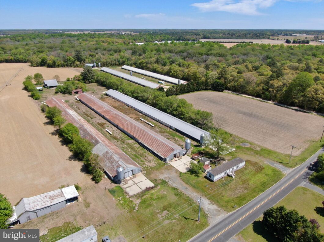 an aerial view of a farm and a road