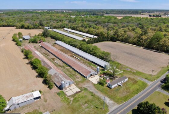 an aerial view of a farm and a road