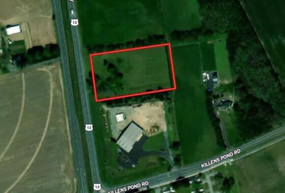 an aerial view of a field with a red square in the middle