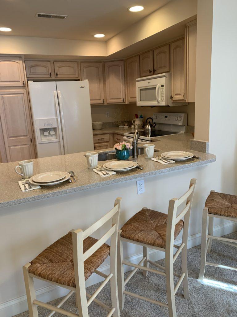 unit dining counter with stools and full kitchen