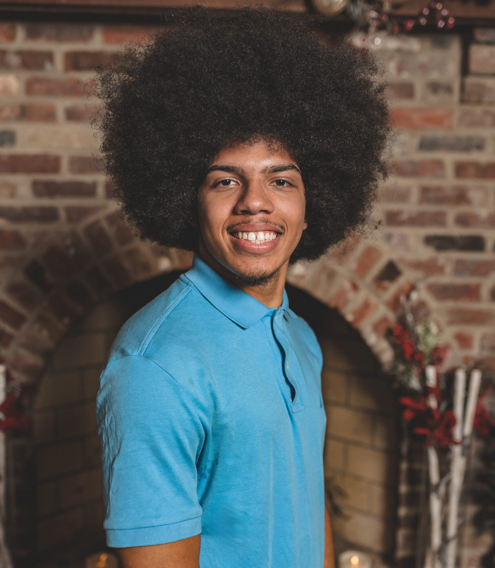 A male wearing a blue shirt smiling.