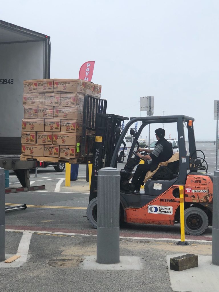 Thrashers potatoes in boxes being delivered