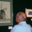 Man looking at artwork of lighthouse