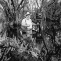 Man taking photo in nature black and white