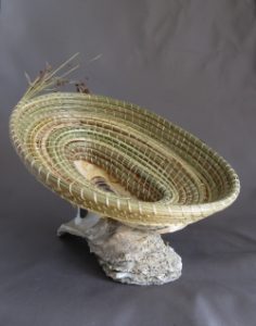 Woven green basket on rock