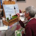 Women painting lighthouse