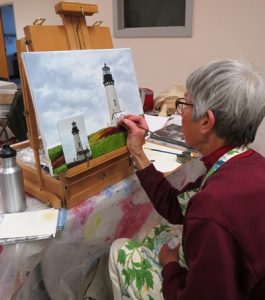 Women painting lighthouse