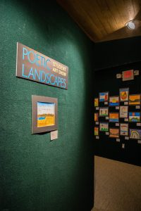 Room with sign Poetic Landscapes Student Art Show