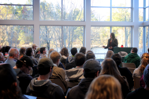 Women lecturing large group of people