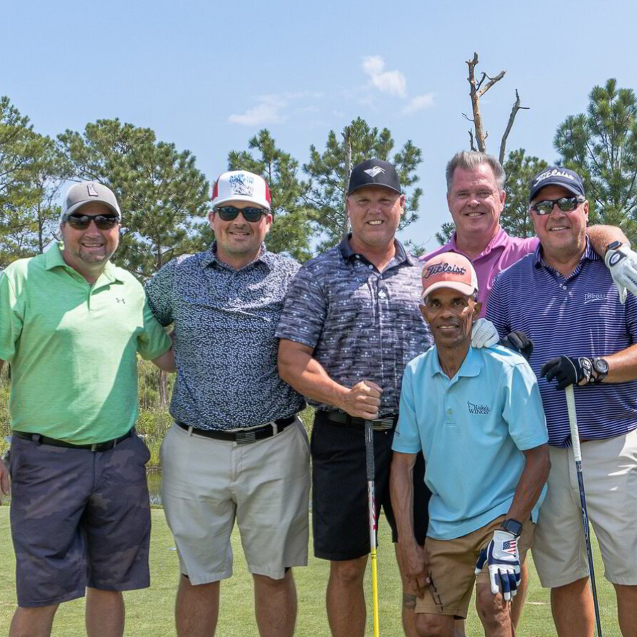 a group of men standing next to each other on a field