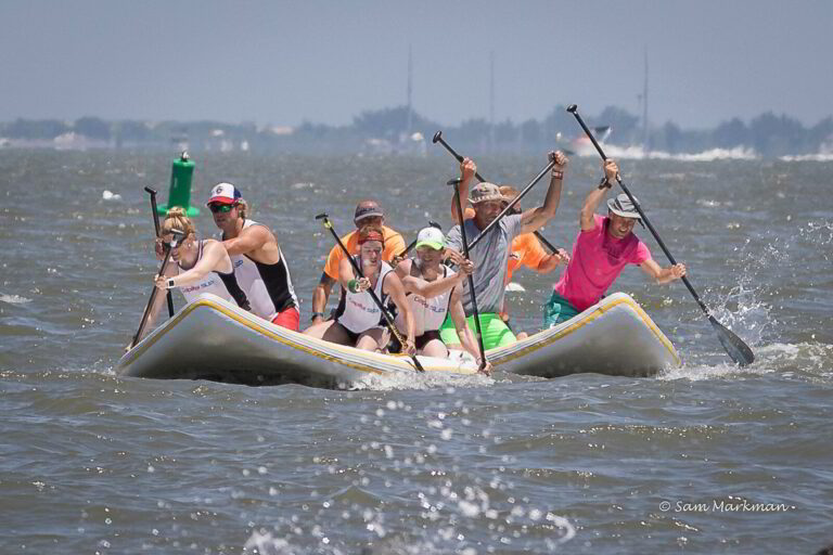 a group of people riding on the back of a boat